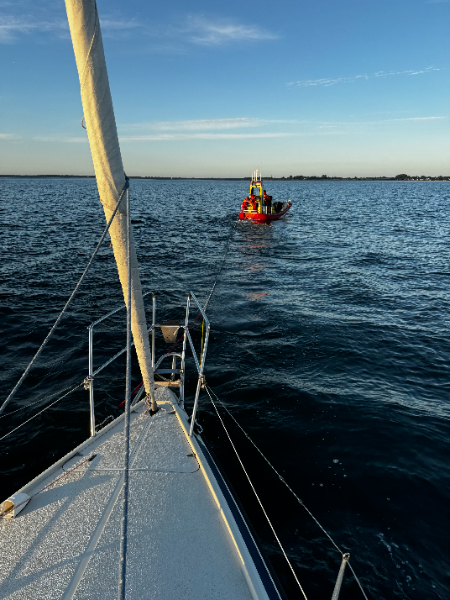 Our sailboat being tugged by another boat