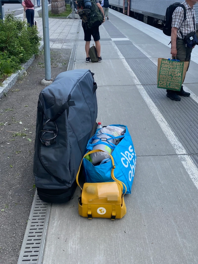 The big black bike bag and and another bag